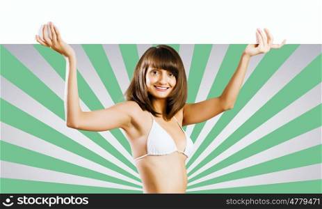 Girl with banner. Young pretty girl in bikini holding blank banner