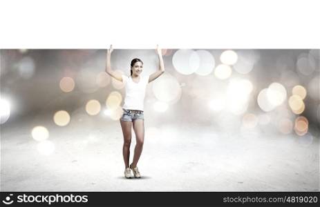 Girl with banner. Young pretty girl in shorts holding white blank banner