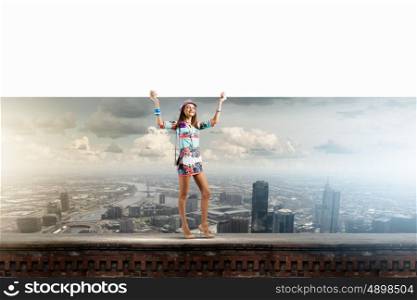 Girl with banner. Young pretty lady in colored dress holding white banner. Place for text