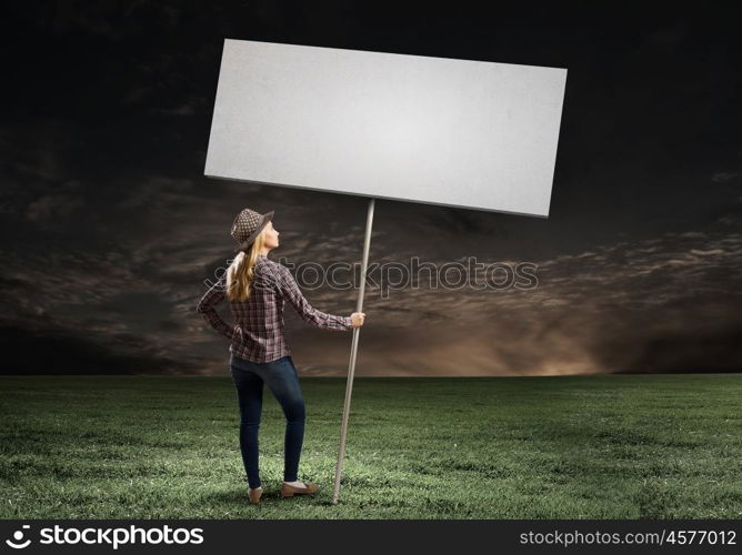 Girl with banner. Young woman in casual carrying white blank banner