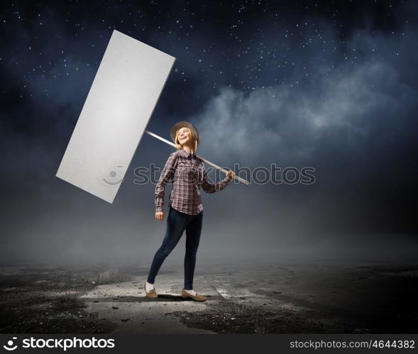 Girl with banner. Young woman in casual carrying white blank banner
