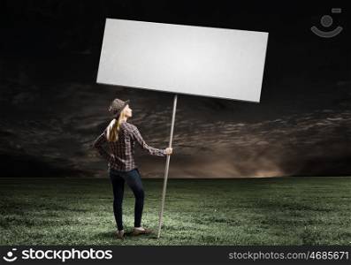 Girl with banner. Young woman in casual carrying white blank banner