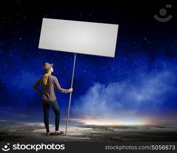 Girl with banner. Young woman in casual carrying white blank banner