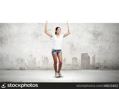 Girl with banner. Young woman in casual holding white blank banner. Place for text