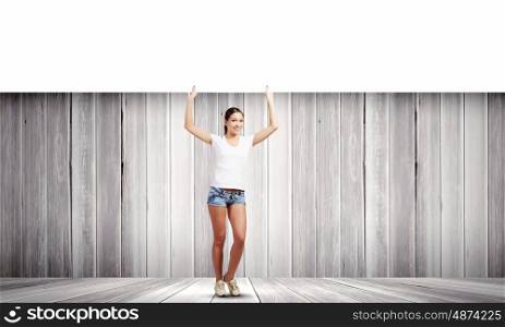 Girl with banner. Young woman in casual holding white blank banner. Place for text
