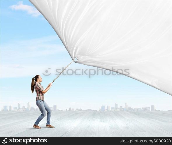 Girl with banner. Young woman in casual pulling white blank banner