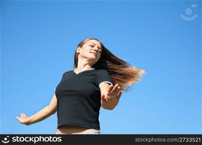 Girl with being fluttered hair on sky