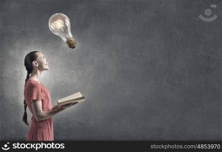 Girl with book. Close up of woman in red dress with book in hands