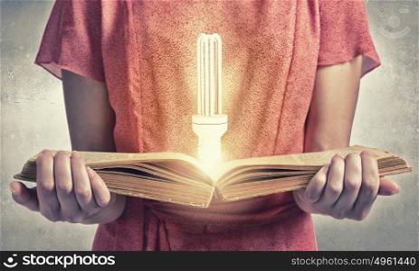 Girl with book. Close up of woman in red dress with book in hands