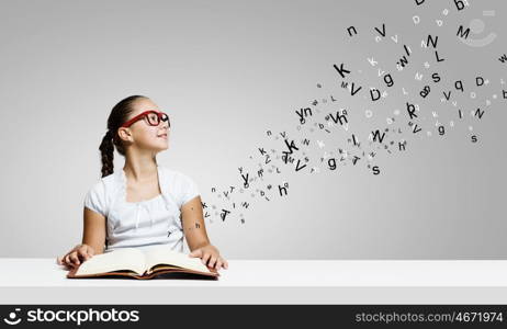 Girl with book. Cute girl of school age with book in hands