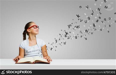 Girl with book. Cute girl of school age with book in hands