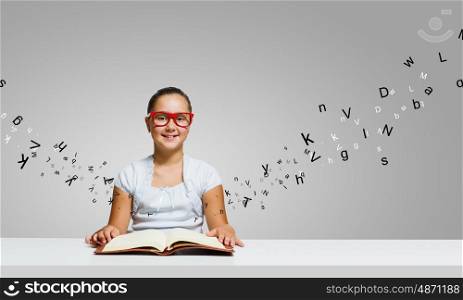 Girl with book. Cute girl of school age with book in hands