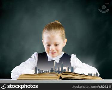 Girl with book. Cute school girl looking in opened book with city model