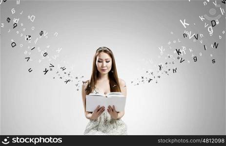 Girl with book. Young asian woman in dress with book in hands