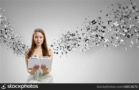 Girl with book. Young asian woman in dress with book in hands