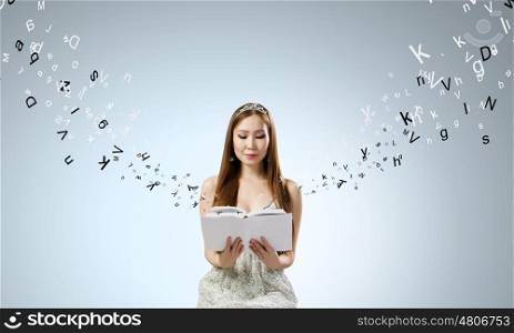 Girl with book. Young cute woman reading book an characters flying around