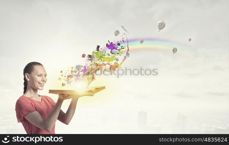 Girl with book. Young emotional woman in red dress with book in hands