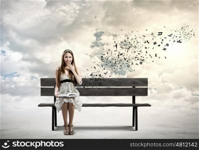Girl with book. Young pretty asian woman sitting on bench and reading book