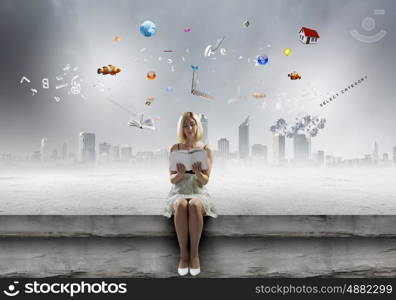 Girl with book. Young pretty woman sitting on bench and reading book