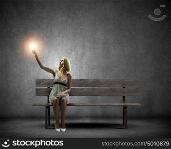 Girl with book. Young pretty woman sitting on bench and reading book
