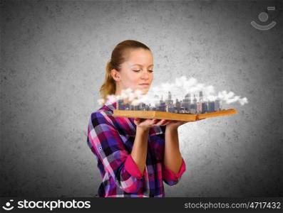 Girl with book. Young woman in casual holding opened book with city model