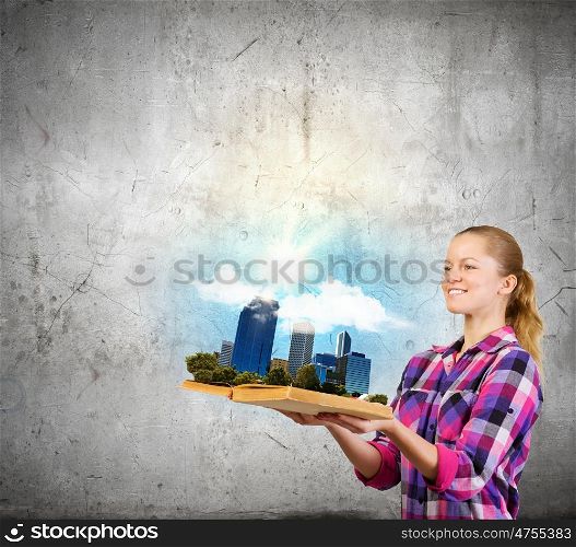 Girl with book. Young woman in casual holding opened book with city model