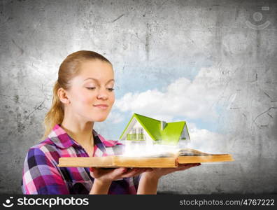 Girl with book. Young woman in casual holding opened book with green tree