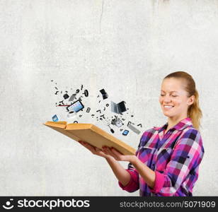 Girl with book. Young woman in casual holding opened book with icons flying out