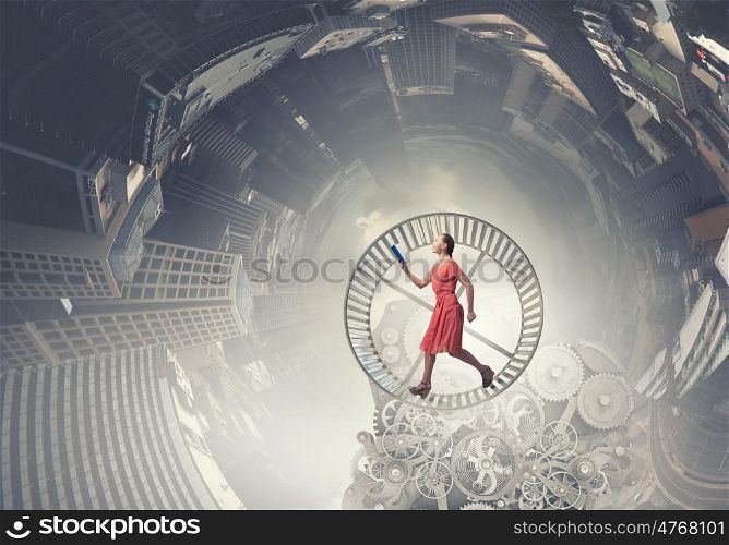 Girl with book. Young woman in red dress running in wheel with book in hand