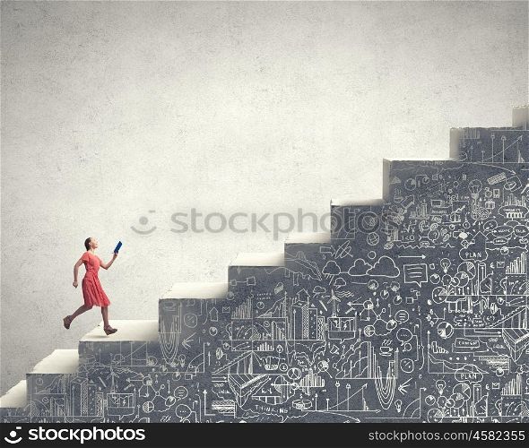 Girl with book. Young woman in red dress running with book in hand