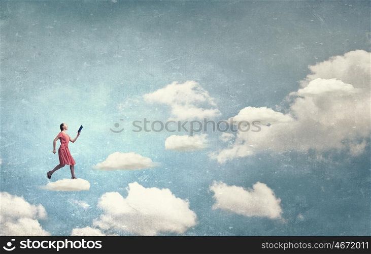 Girl with book. Young woman in red dress running with book in hand