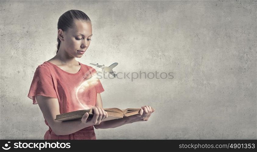 Girl with book. Young woman in red dress with book in hand