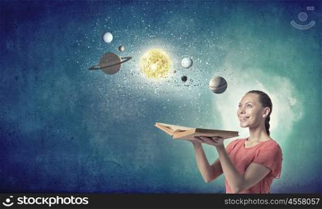 Girl with book. Young woman with book exploring planets of sun system