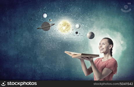 Girl with book. Young woman with book exploring planets of sun system