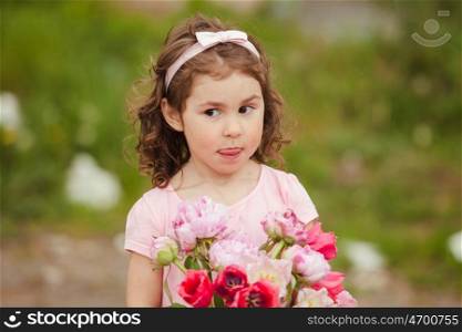 Girl with bouquet of pink flowers for mom on mother&amp;#39;s day selebratinf