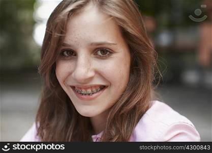 Girl with braces smiling into camera