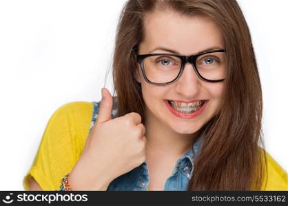 Girl with braces wearing geek glasses showing thumb up isolated
