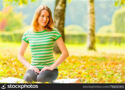 girl with brown eyes resting on the grass and looking to the side