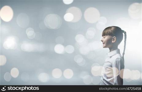Girl with closed eyes. Side view of cute girl against bokeh background
