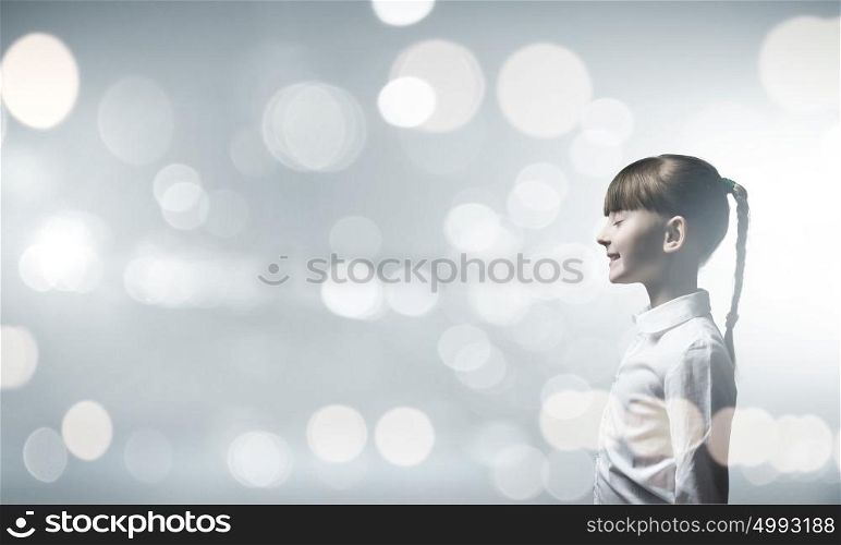 Girl with closed eyes. Side view of cute girl against bokeh background