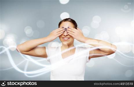 Girl with closed eyes. Young woman in white shirt closing eyes with palms