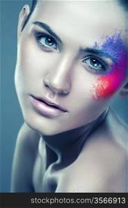 girl with coloured powder above eye