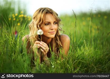 Girl with dandelion on spring meadow i wish concept. Girl with dandelion i wish