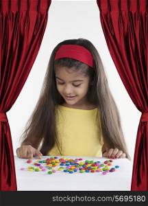 Girl with different coloured sweets