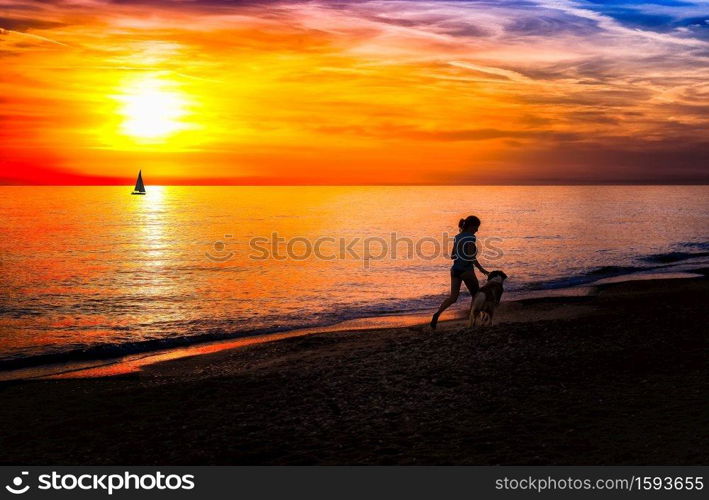 Girl with dog on the beach