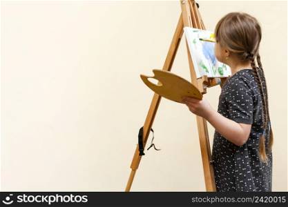 girl with down syndrome painting with copy space