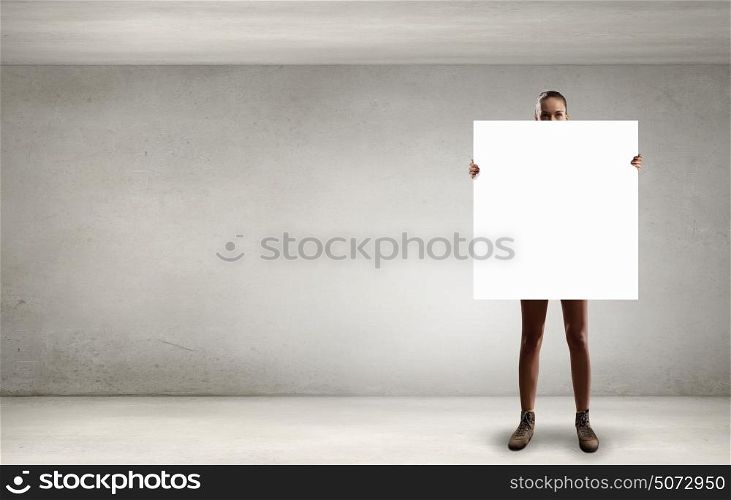 Girl with empty banner. Young woman in sunglasses showing white blank banner
