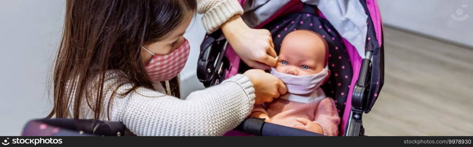 Girl with face mask putting mask on her baby doll in the stroller