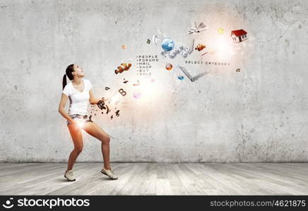 Girl with guitar. Young girl in shorts playing on imaginary guitar