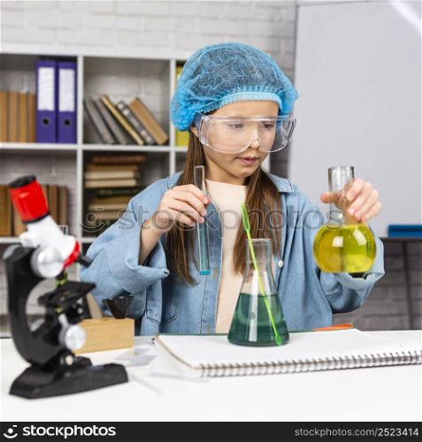 girl with hair net doing science experiments